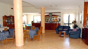 A spacious lobby with a dining area, a bar, and a seating area. - Hotel Villaggio Aurora (Manduria)