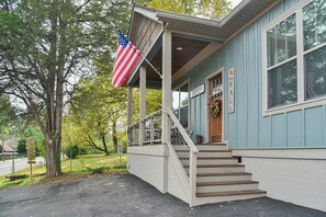 A building with a porch, a staircase, and an American flag. - The Montreat House (Black Mountain)