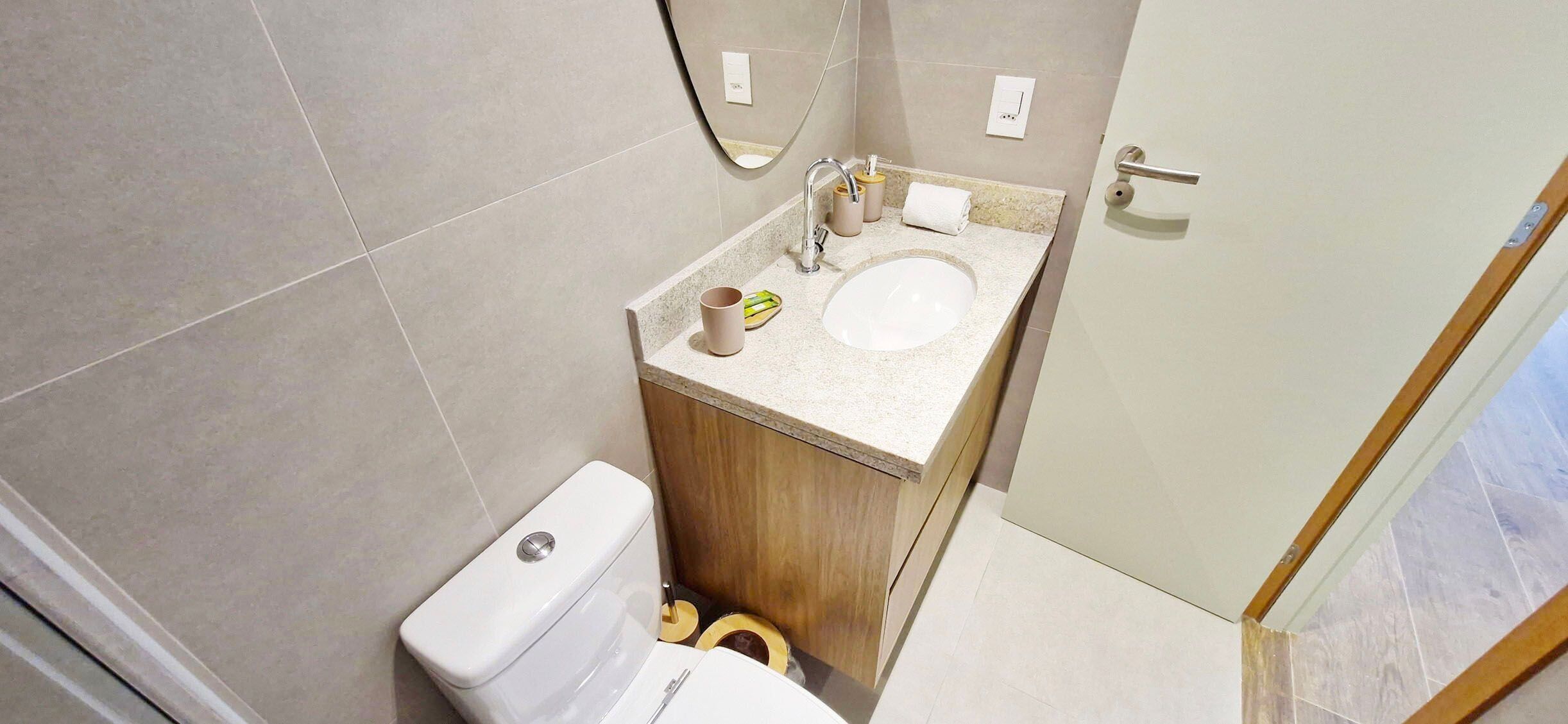 A bathroom with a toilet, sink, and shower area.