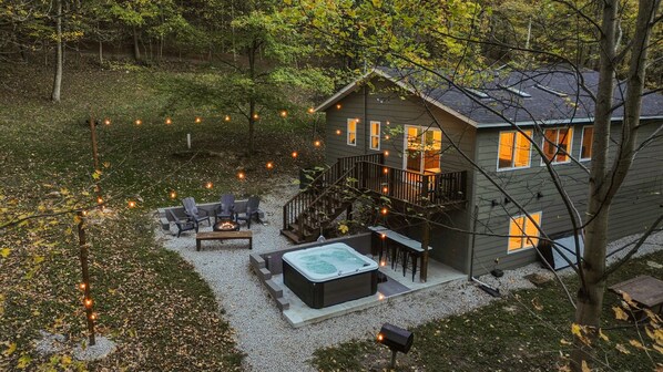 A two-story house with a deck, outdoor seating, and a hot tub. - The Haven @ Hocking | Luxury Retreat, Hot Tub (Rockbridge)