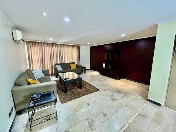 Classic Apartment, Balcony, City View | Living area | Flat-screen TV, DVD player