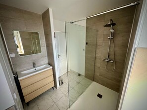 Een douche, een haardroger, zeep, toiletpapier