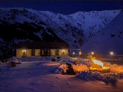 A Private Guest House in a secluded area by the river, surrounded by mountains.