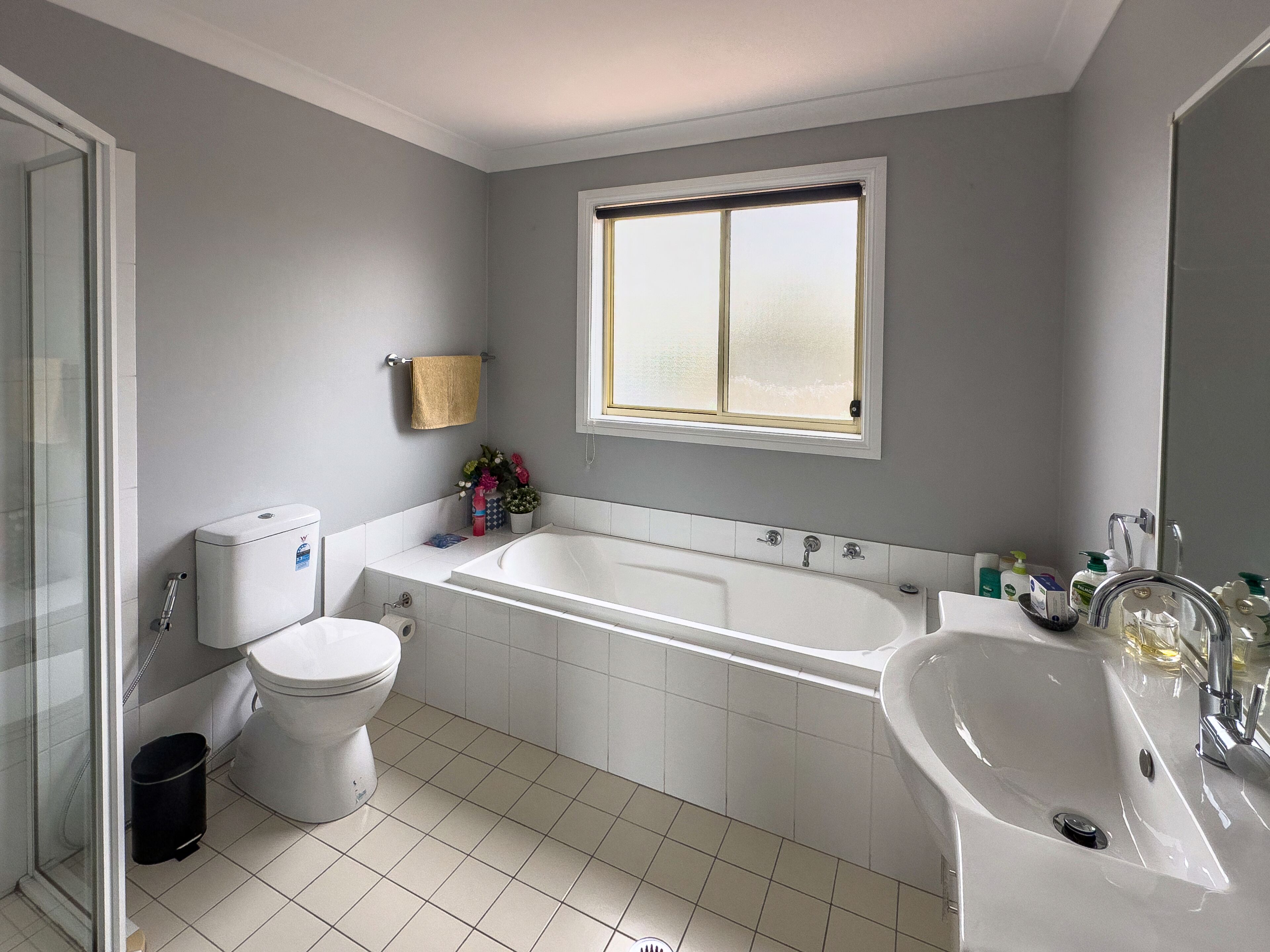 A bathroom with a bathtub, toilet, and sink.
