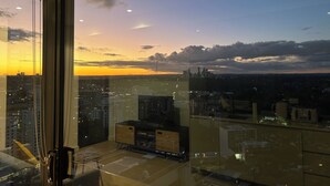 A cityscape at sunset with buildings and a clear sky. - Kozyguru |St Leonards | 1 Bed Best Location & View (St Leonards)