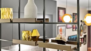 Um interior moderno com uma estante geométrica exibindo diversos objetos decorativos.