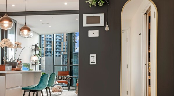 Un interno moderno con zona pranzo, cucina e vista su edifici alti.
