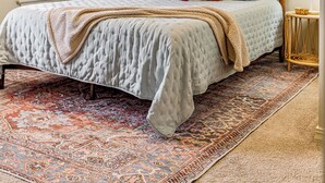 A bedroom with a bed, a ceiling fan, a window with blinds, a painting on the wall, and a rug. - Charming house minutes from everything in Monroe/West Monroe! 5-Star hosts! (West Monroe)