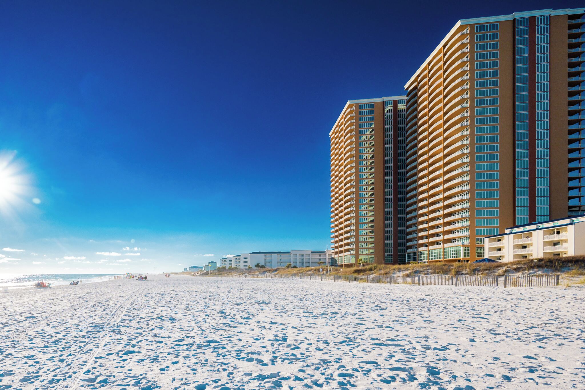 Relax on the beautiful white sand beach, just steps away from your rental at Phoenix Gulf Towers in Orange Beach