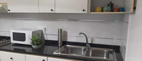 Fridge, microwave, stovetop, coffee/tea maker
