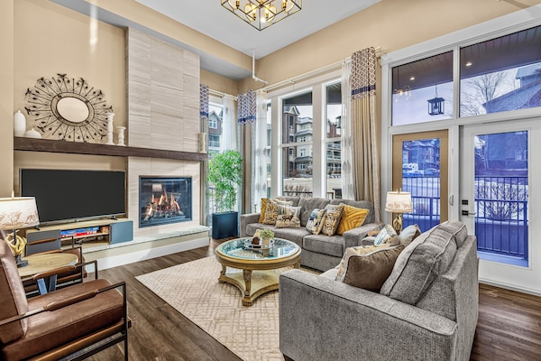 Spacious living room with soaring ceilings and abundant natural light.