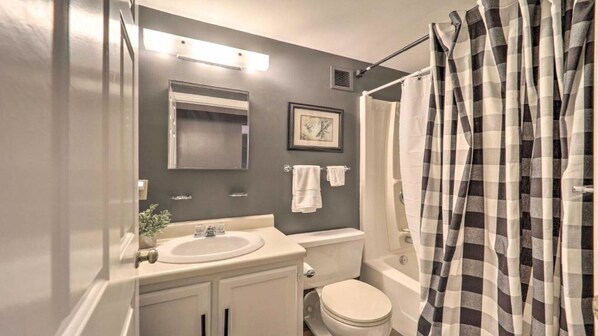 A bathroom with a sink, mirror, toilet, and shower curtain. - 3 Mi to Skiing: Mtn-View Condo in Sugar Top Resort (Sugar Mountain)