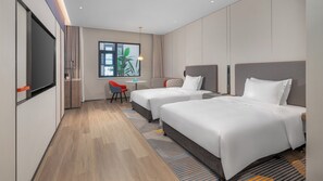 A hotel room with two beds, a small table, a chair, and a TV. - Holiday Inn Express Xi An Caotang Technology Park by IHG (Xi'an)
