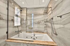 A modern bathroom with a glass-enclosed shower, a freestanding bathtub, marble walls, and a wooden vanity. - 5 Bed Villa,2 Private Beaches, Pool by Estatesmen (Dubai)