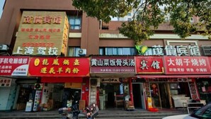 A street view with multiple storefronts, including a restaurant and a repair shop. - Shanghai Maoyi Hotel (Shanghai)
