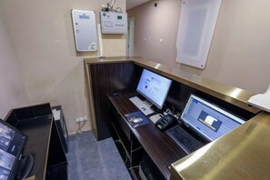 A hotel room with a desk, two computers, a telephone, and a wall-mounted control panel. - 100 Inn (Shanghai Pudong Jinqiao) (Shanghai)