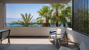 A balcony with a view of the sea, palm trees, and a table with a bottle and glasses. - Paoma Middle Floor No.2 (Podstrana)