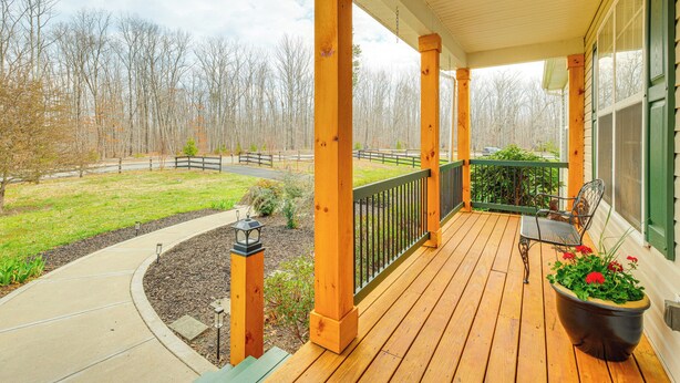 A wooden porch with a curved pathway, a bench, and a planter with flowers. - Private Deck & Views: Rural Virginia Escape (Gordonsville)
