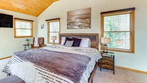 A bedroom with a large bed, wooden ceiling, and two windows with blinds. - 5 Mi to Cherokee Lake: Pet-Friendly Cabin w/ Deck! (Murphy)