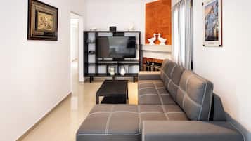Deluxe Apartment, Sea View | Living area | TV