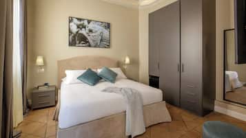 A bedroom with a bed, nightstands, a wardrobe, a painting, and a mirror.