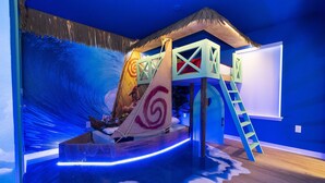 A room with a thatched-roof playhouse, a slide, and a large whiteboard. - 8941- Great Family Home near Disney, private pool - Windsor at Westside Resort (Kissimmee)