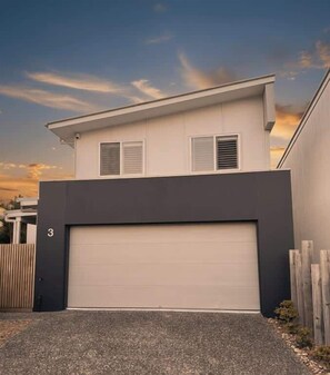 A modern two-story house with a garage, a number '3' on the wall, and a wooden fence. - Sunshine on Saltwater (Kingscliff)