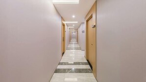 A long, narrow hallway with a marble floor and light-colored walls. - F1 Business Hotel (Shanghai Xinhua Hospital) (Shanghai)