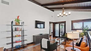 A modern living room with a fireplace, a bookshelf, a sofa, and a coffee table. - NEW! 3 Houses 2 the Sand-Spacious Gorgeous Remodel (Oxnard)