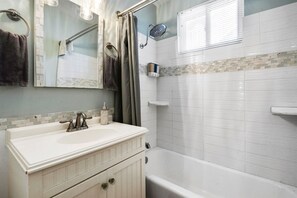 A bathroom with a white sink, vanity, and bathtub. - 360 Ocean View Roof Deck, 50 Steps to Beach+AC! (Oxnard)
