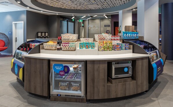 A self-service beverage kiosk with a variety of snacks and drinks.
