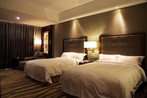 A hotel room with two beds, a nightstand, a lamp, and a large window with curtains. - Qingcheng Hotel (Qinghe)