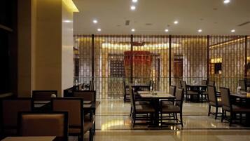 A restaurant with tables and chairs arranged for dining.
