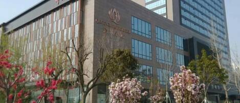 A modern building with a sign that reads 'Qingdao University.'
