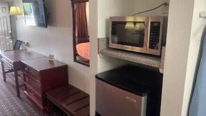 A compact kitchenette with a microwave and a refrigerator.