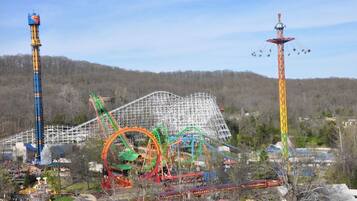 A theme park with various rides and structures, including a tall tower and a roller coaster.