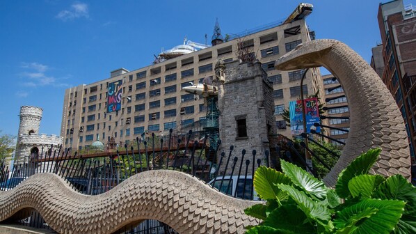A building with a large, decorative metal fence in front.