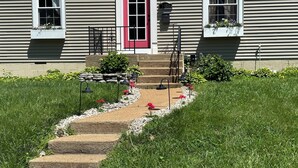 A two-story house with a red door, white window frames, and a mailbox. - Cozy Cottage in the City (Saint Ann)