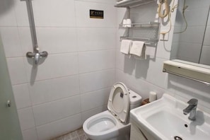 A small, clean bathroom with a toilet, sink, and shower. - Shijiazhuang Yiguang Hotel (Shijiazhuang)
