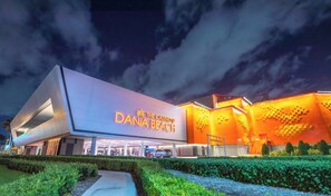 The Casino at Dana Beach with a modern design and illuminated signage.