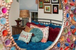 A bedroom with a bed, pillows, a lamp, and framed artwork on the wall. - Boho Buffalo: Luxe Texas Hideaway in The Gap (Buffalo Gap)