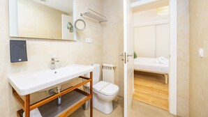 A bathroom with a sink, toilet, and a mirror. - Hostal Boutique Canyamel, 112 Double Room with Sea View, Private Terrace, Wi-Fi and Air Conditioning (Canyamel)