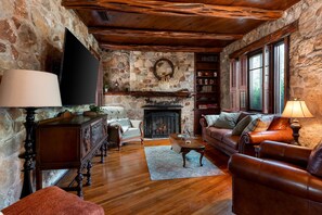 Smart TV, fireplace, books, computer monitors