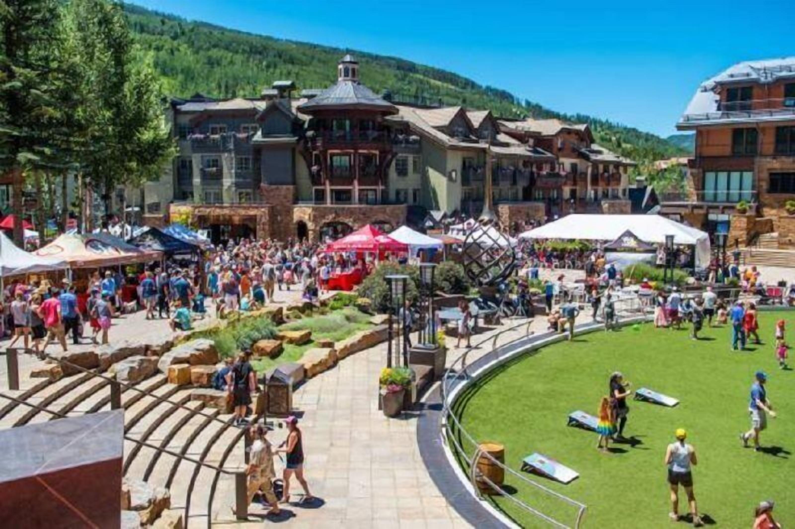 A bustling outdoor area with a pool, surrounded by buildings with traditional architecture.