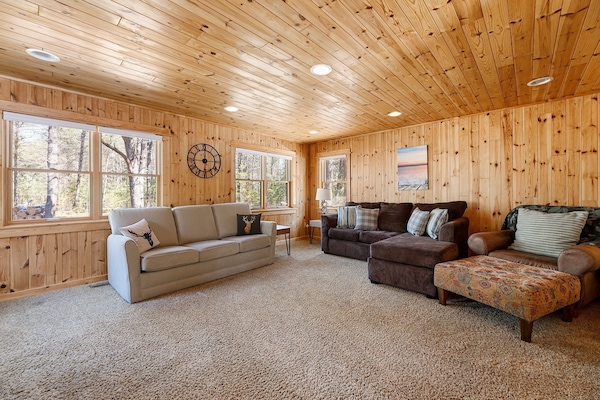 Vaulted wood ceilings & plush seating create a warm, lodge-style living space made for cozy nights in.