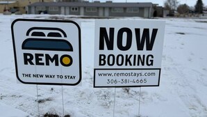 Two signs advertising a new way to stay and now booking available.