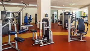 A gym with various exercise machines, including weight benches and cardio equipment. - 2BR at the Palm | Balcony, Pool, Gym & Beach (Dubai)