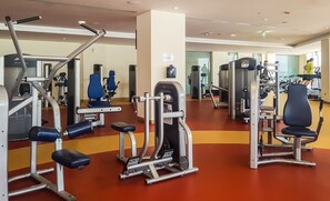 A gym with various exercise machines, including weight benches and cardio equipment.