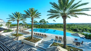 A pool area with palm trees, lounge chairs, and a view of the ocean. - ☀️Infinity Pool-4BR-30A Cypress Stay (Santa Rosa Beach)