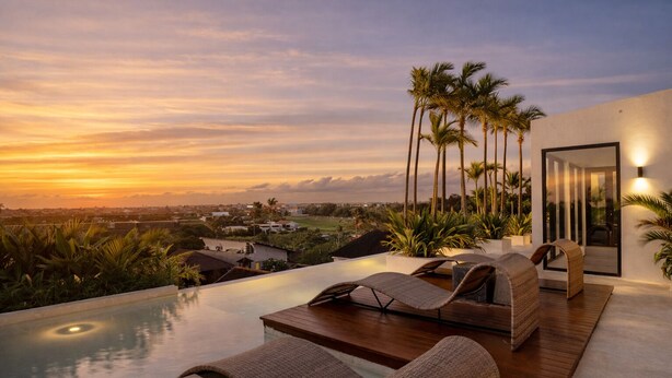 A rooftop infinity pool with lounge chairs, palm trees, and a sunset view. - A.K.A Berawa Living #2 Canggu (Canggu)